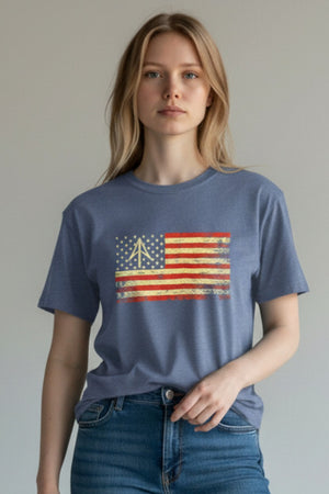 Person wearing a blue t-shirt with an American flag design on a plain background